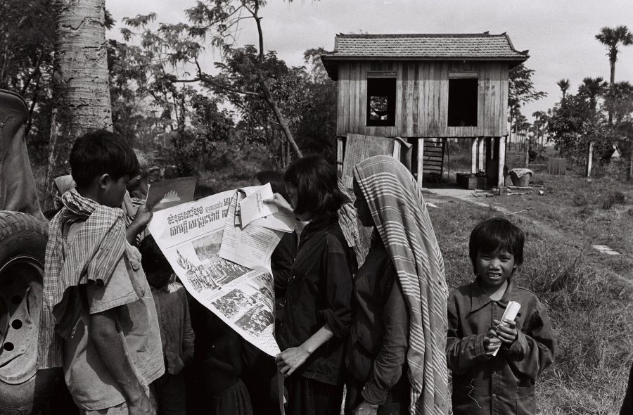 Village children looking at a poster