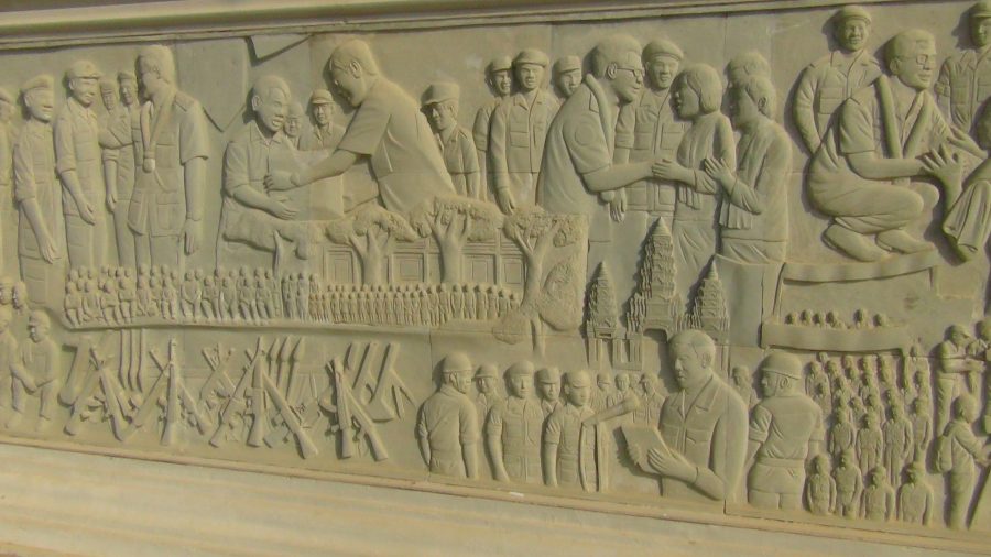a bas relief depicting soldiers and political leaders